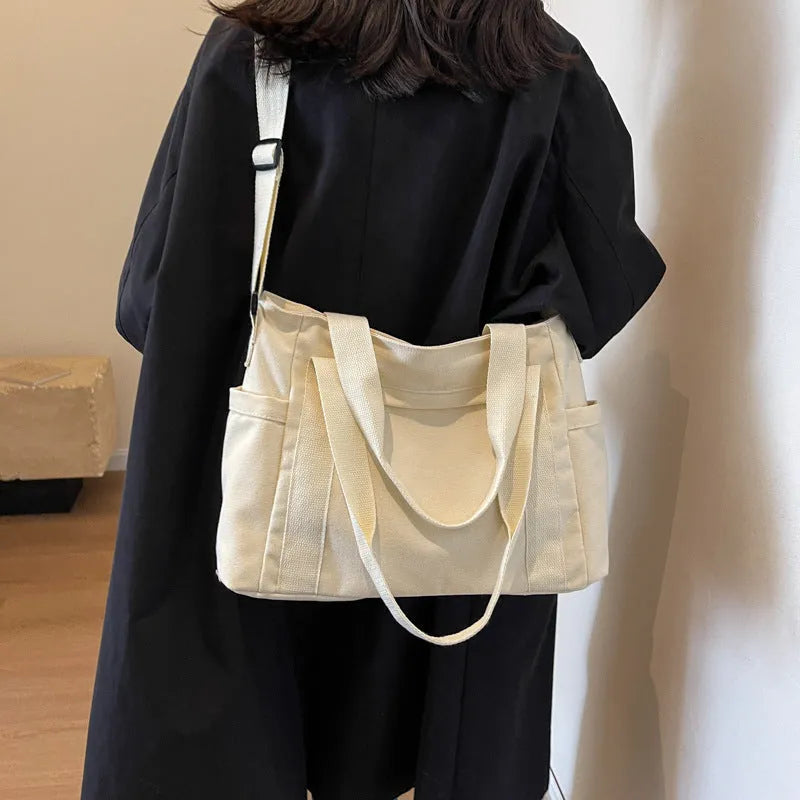 Large capacity polyester canvas shoulder bag in solid colour with sandwich pocket