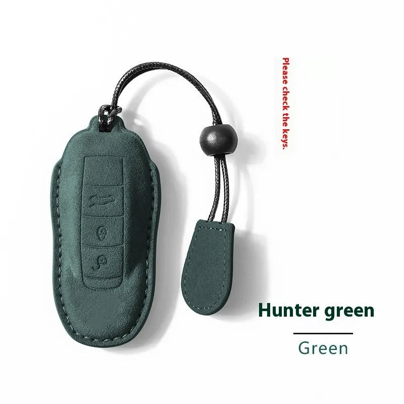 Suede car key cover shown in Cement Gray, Dark Green, Light Gray, and Orange colour options.