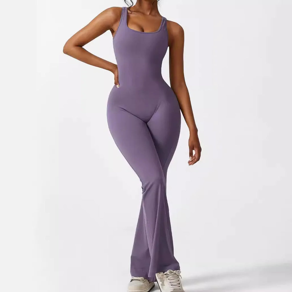 Woman wearing a sleeveless army green flare-leg jumpsuit for yoga or casual wear.