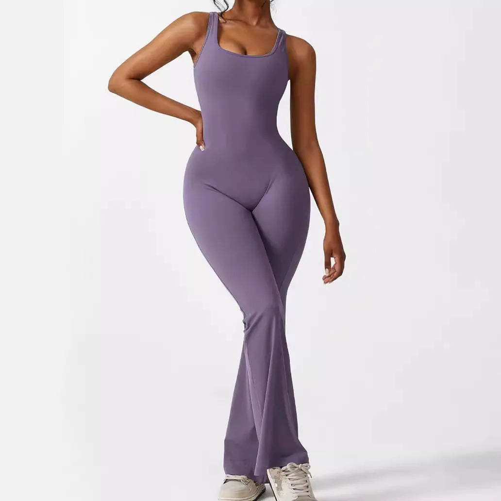 Woman wearing a sleeveless army green flare-leg jumpsuit for yoga or casual wear.