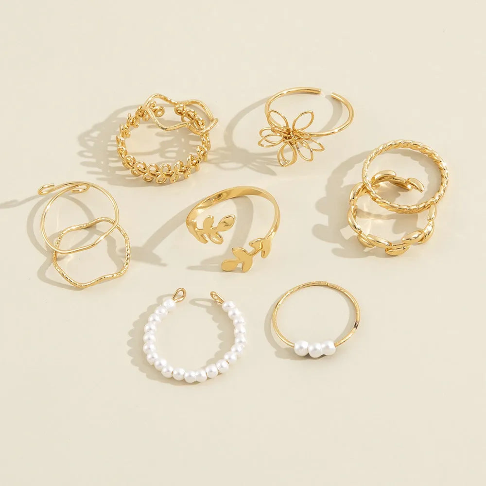 Gold openwork floral pattern alloy ring with electroplated glossy finish