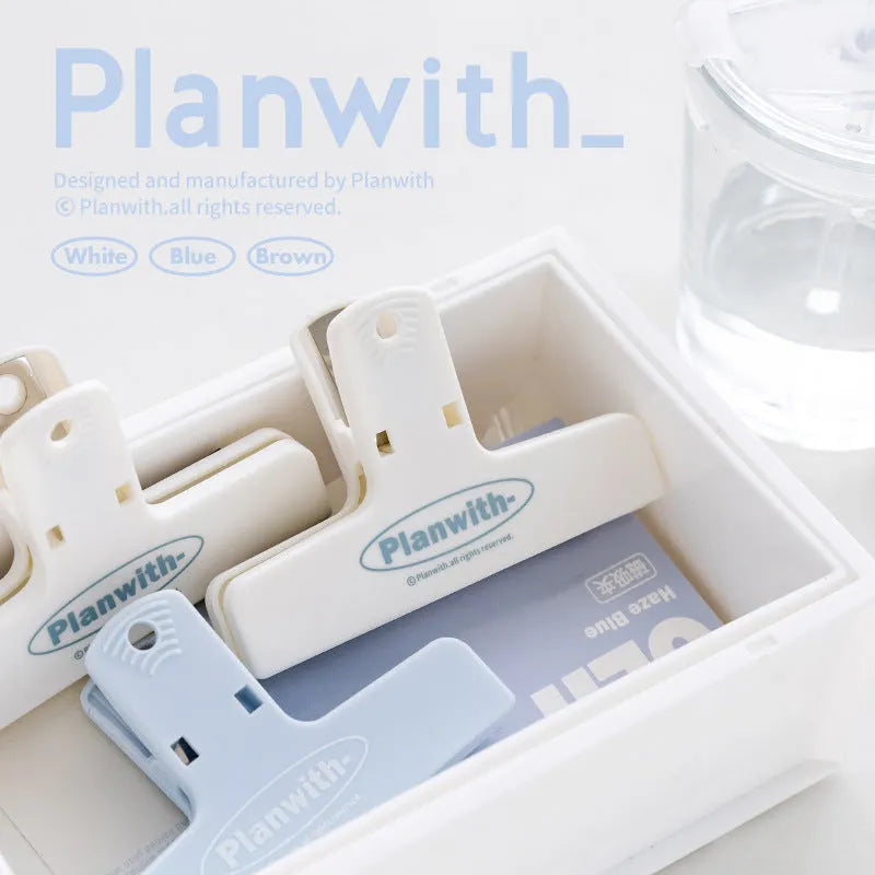 Blue Haze Series magnetic ledger clip holding papers, showing size and magnetic closure