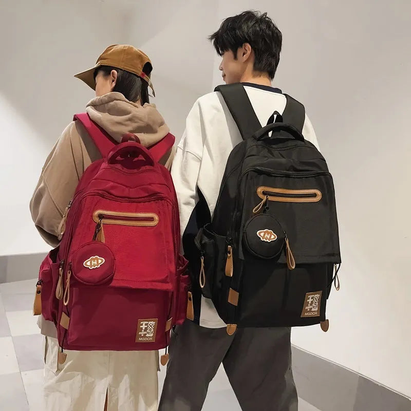 Large-capacity black nylon backpack for middle school students with curved shoulder straps and street style design