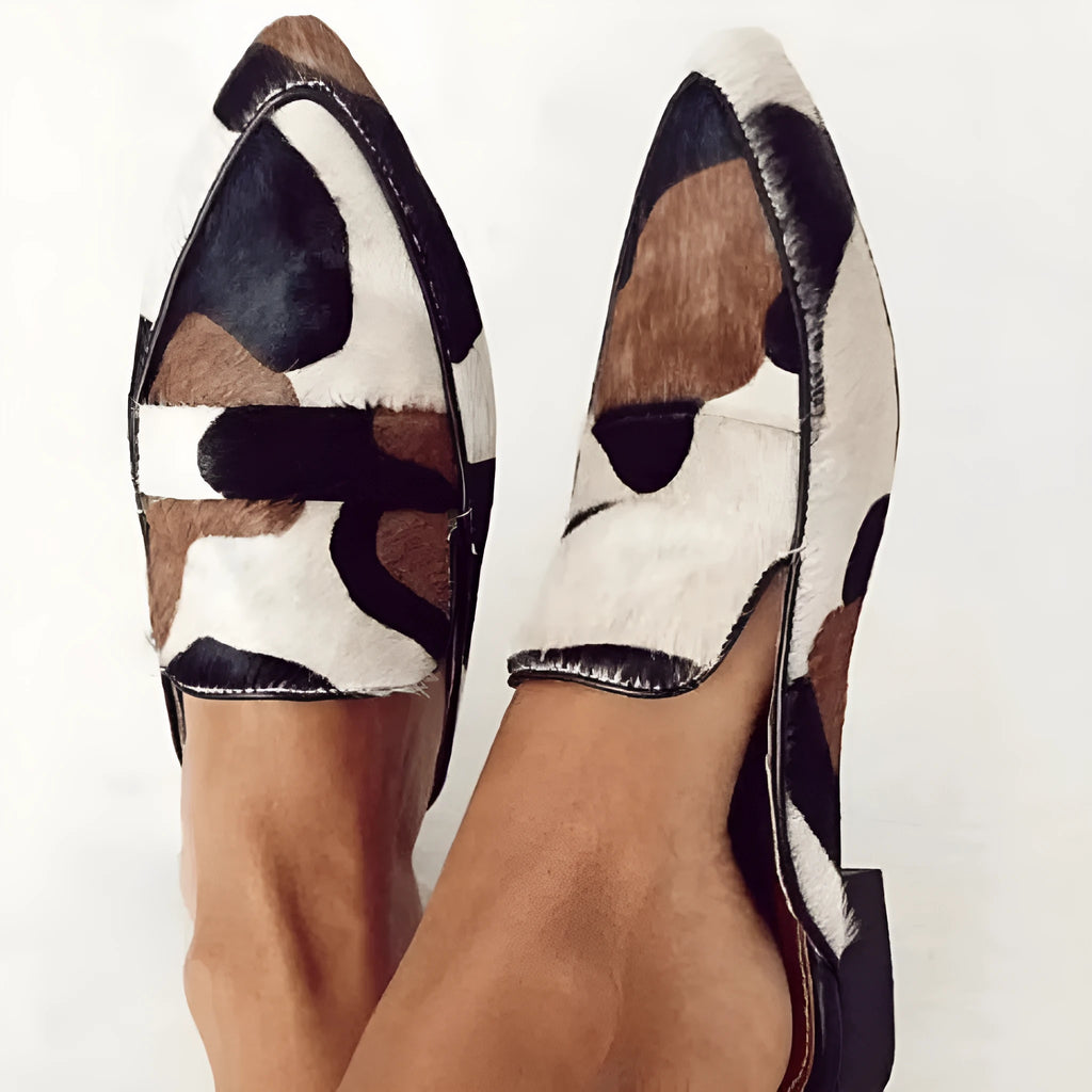 Women's black and white apricot retro pointed-toe low heel suede shoes with imitation horse hair pattern on a white background.