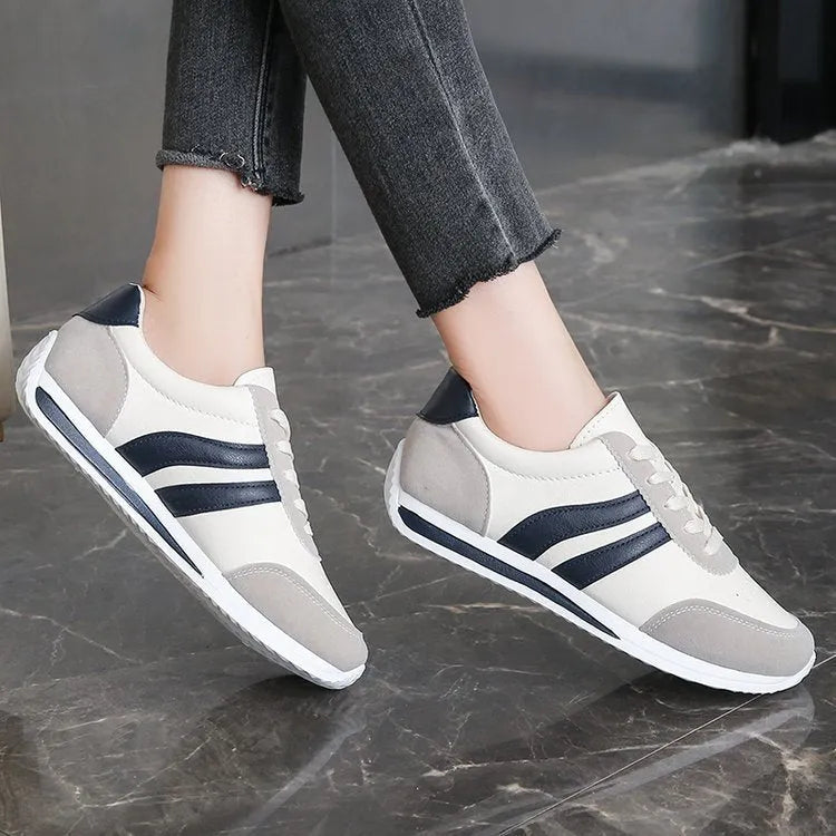Red and blue lace-up running sneakers with mesh upper and flat rubber soles