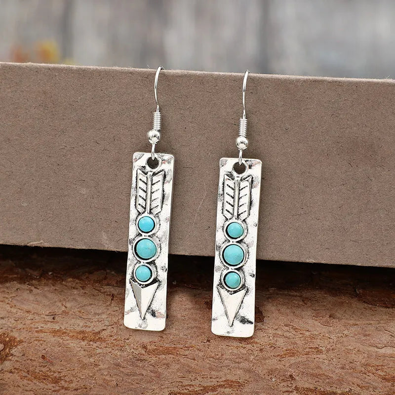 Long silver geometric earrings with turquoise inlay details on zinc alloy