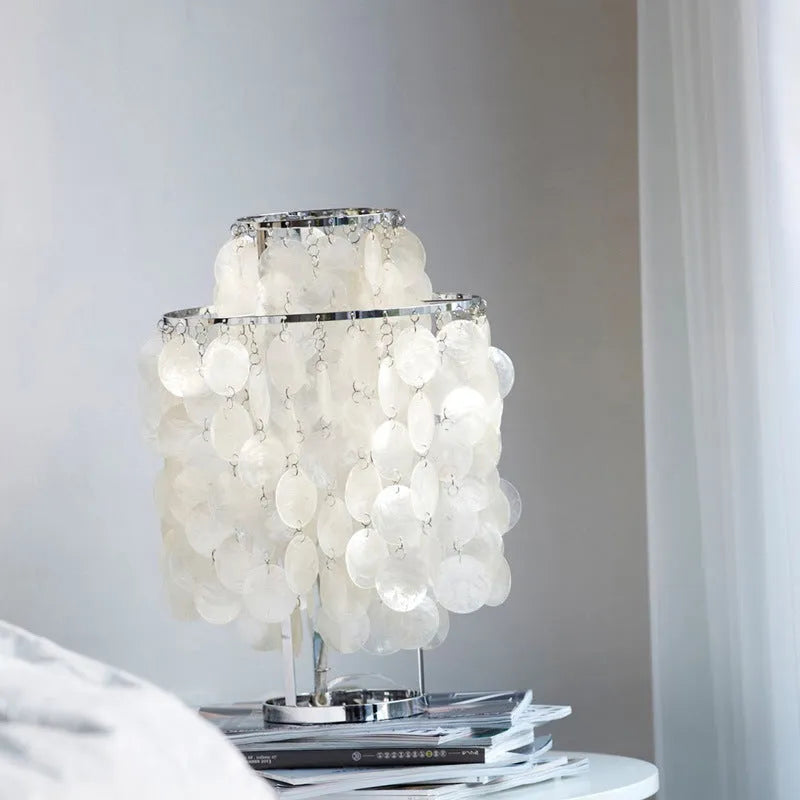 Shell-shaped bedside table lamp with modern design in chrome or gold finish