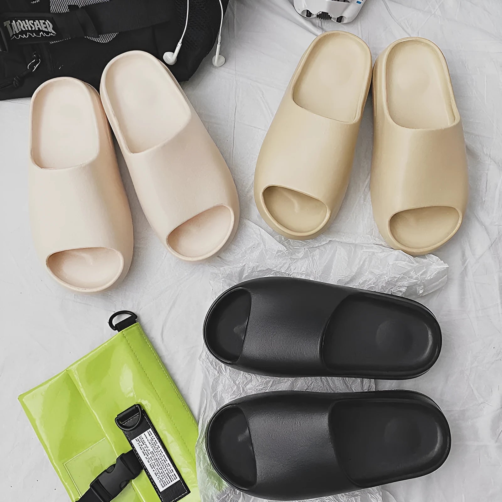 Women's thick-sole beach slippers in beige, shown on a sandy background.