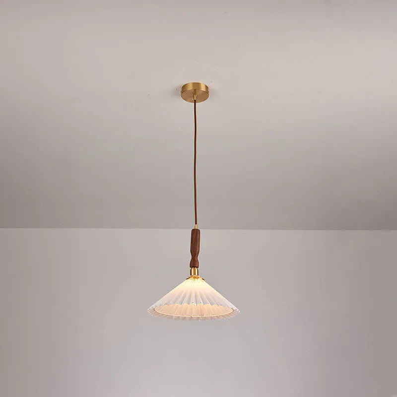 American retro wall lamp with a walnut wood base and white fabric shade mounted on a wall.
