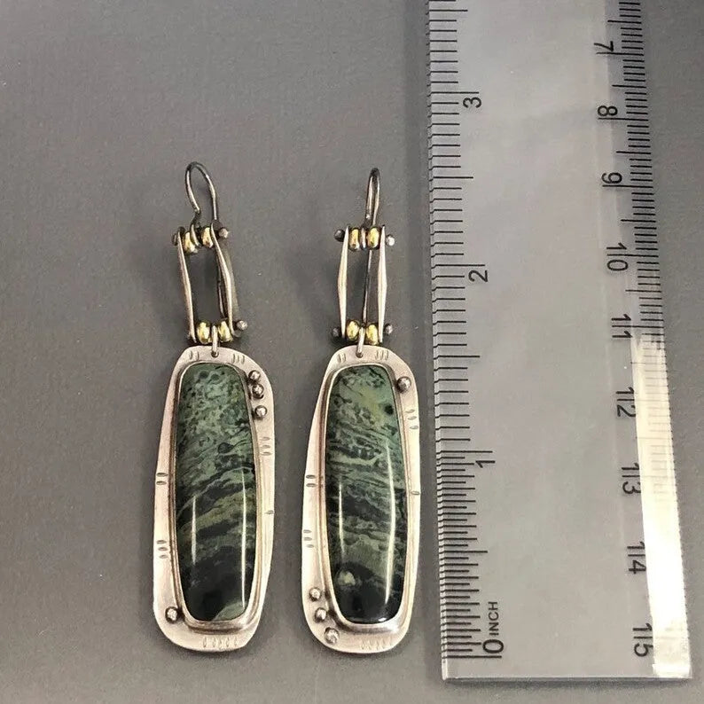 Geometric alloy earrings with two-tone marble pattern design on white background