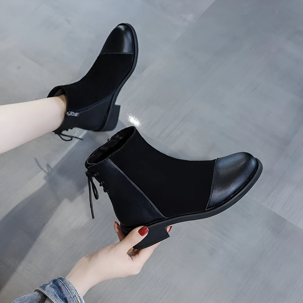 Black knee-high women's Martin boots with a side zipper, round toe, and bow detail.