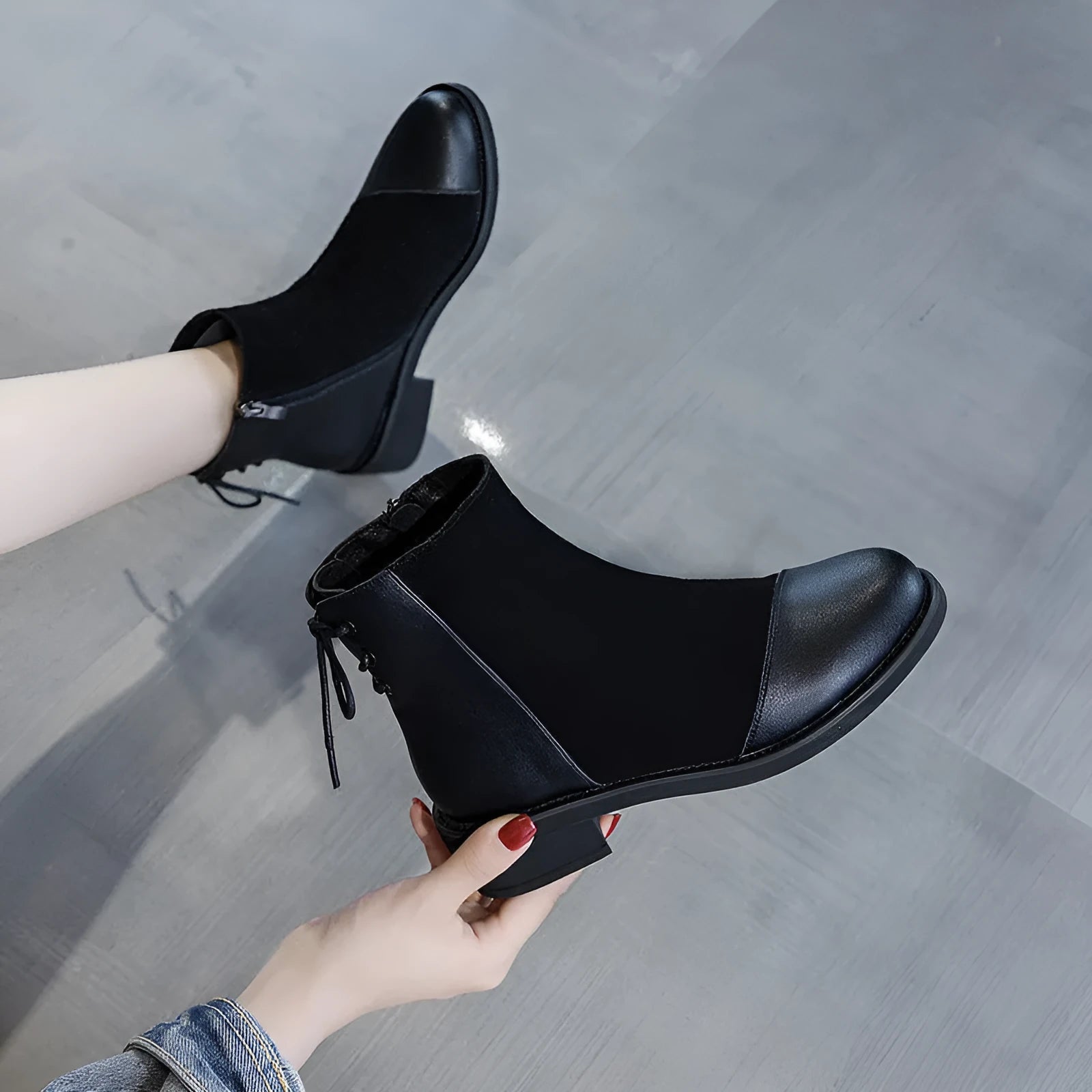 Black knee-high women's Martin boots with a side zipper, round toe, and bow detail.