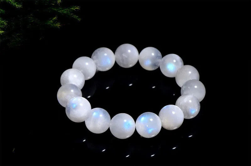 Natural blue moonlight round moonstone bead bracelet on a white background showing polished spherical beads.