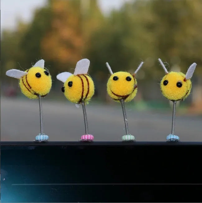 Soft fur bee car decoration on a swing spring for dashboard personalisation.