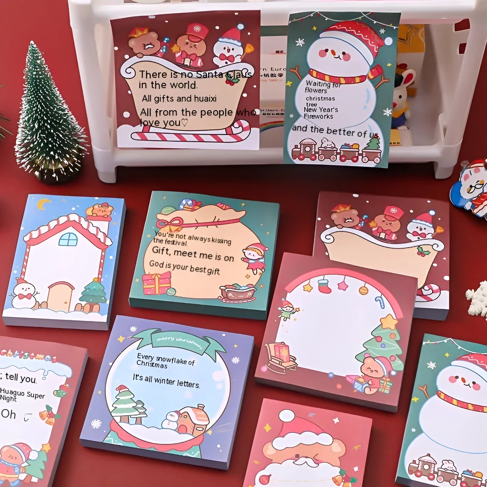 Christmas sticky notes pad with Santa Claus, elf, gift, sled, snowman, bear, house, and crystal ball designs