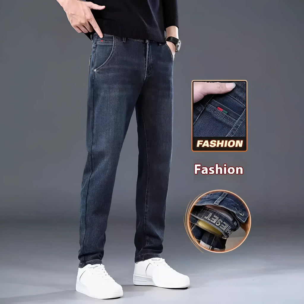 Man wearing blue grey slim straight casual trousers with a loose fit and zip fly for summer street fashion