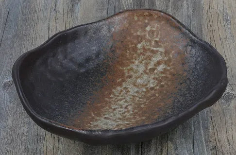 Japanese-style ceramic sashimi bowl with irregular shape and floral decoration