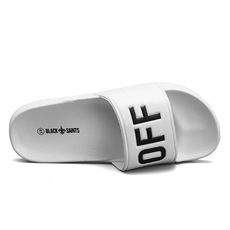 Men's black open-toe slippers with a rubber sole and viscose upper, shown next to a white pair.