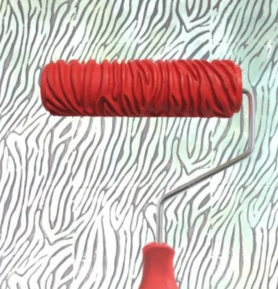 Red rubber paint embossing roller for creating textured wall patterns, approximately 18cm long.