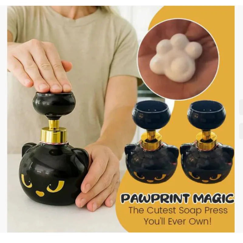 Black plastic cartoon cat-shaped foam soap dispenser on a counter.