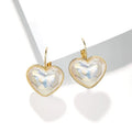 A pair of gold-coloured clip-on earrings with a metallic finish and natural styling.