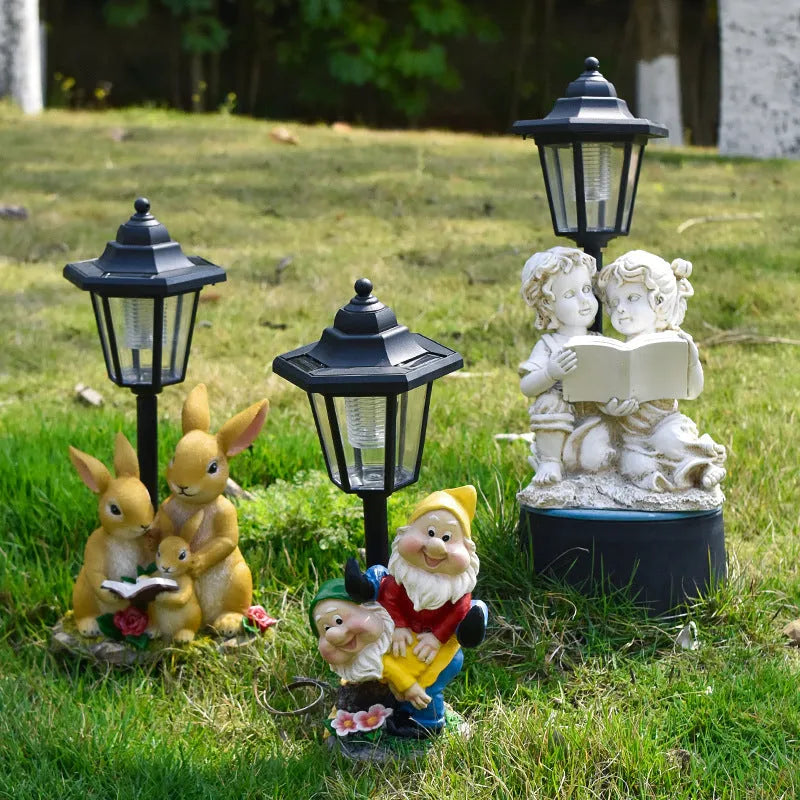 Hexagonal solar garden lamp with decorative resin animal design in outdoor setting