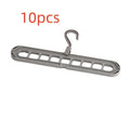 Green plastic hanger with nine holes for hanging multiple trousers or skirts vertically