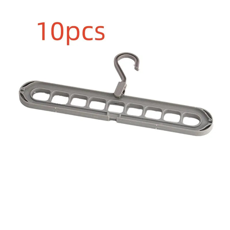 Green plastic hanger with nine holes for hanging multiple trousers or skirts vertically