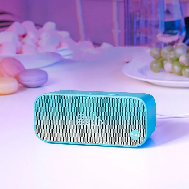 Blue Elf sugar cube shaped AI smart WiFi speaker on a wooden shelf