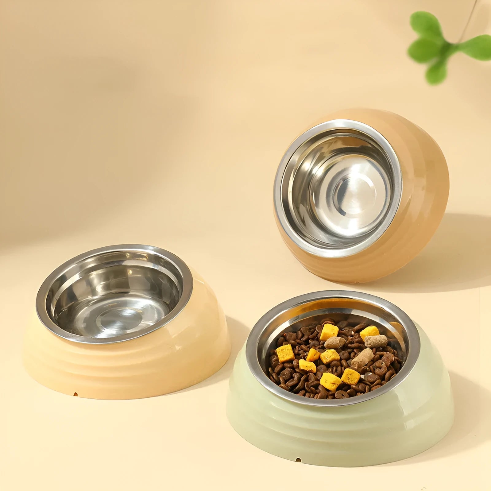 Stainless steel cat bowl in plastic base available in beige, brown, and light green colours