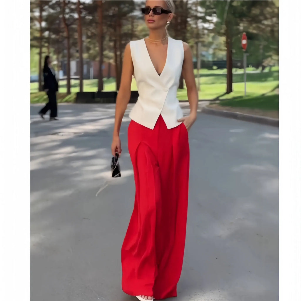Women's beige two-piece set with deep V-neck sleeveless top and high-waisted wide-leg trousers.