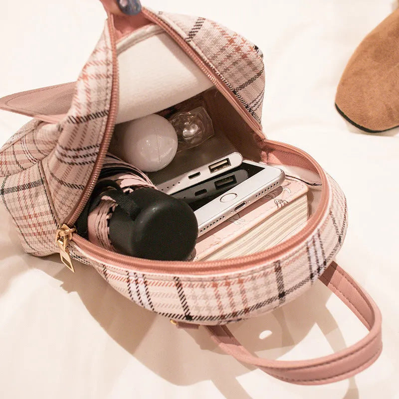 A black one shoulder diagonal phone bag made from PU fabric with an adjustable strap.