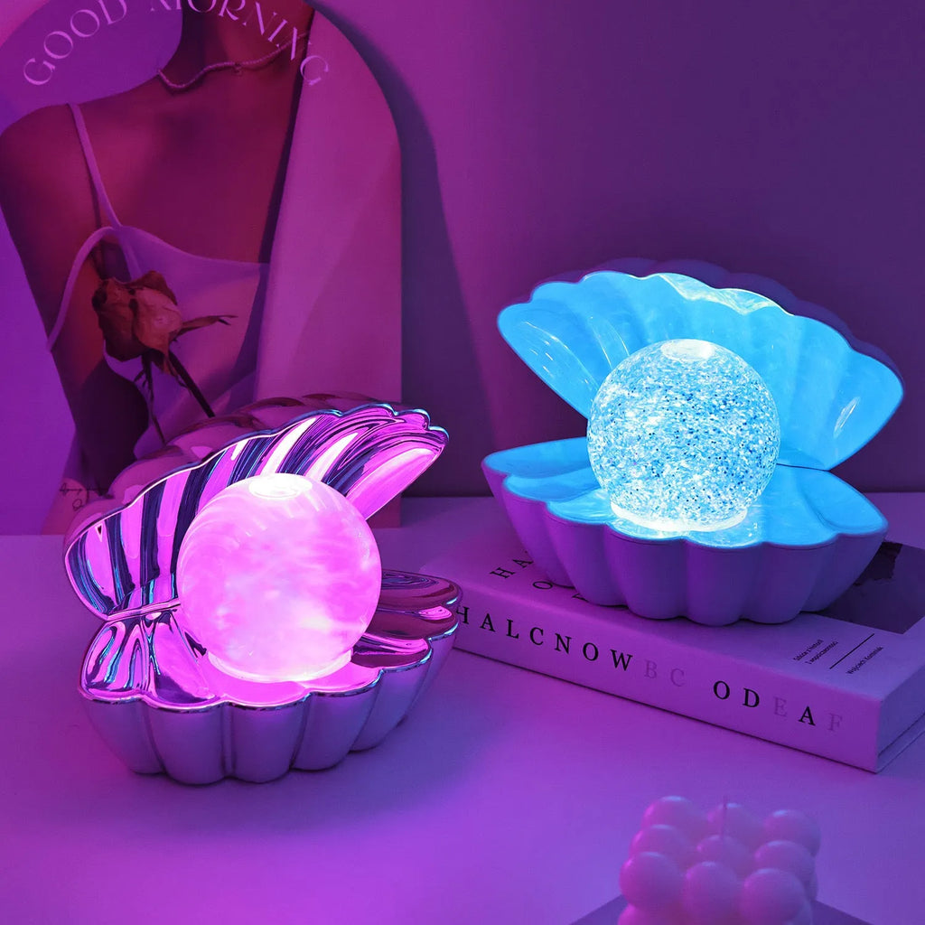 Shell-shaped small night lamp with neon ambience lighting on a table.