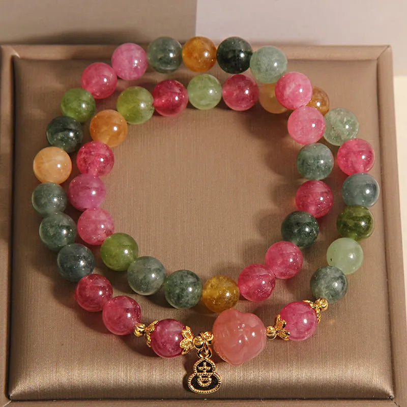 Natural jade colour tourmaline crystal double ring bracelet for women with Buddha head charm on white background
