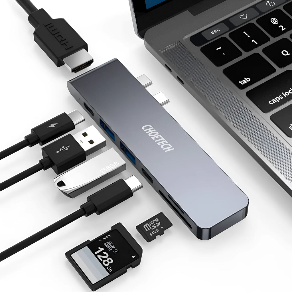 Silver aluminium USB-C hub adapter with SD card slot, HDMI, USB ports, and Thunderbolt 3 connector.