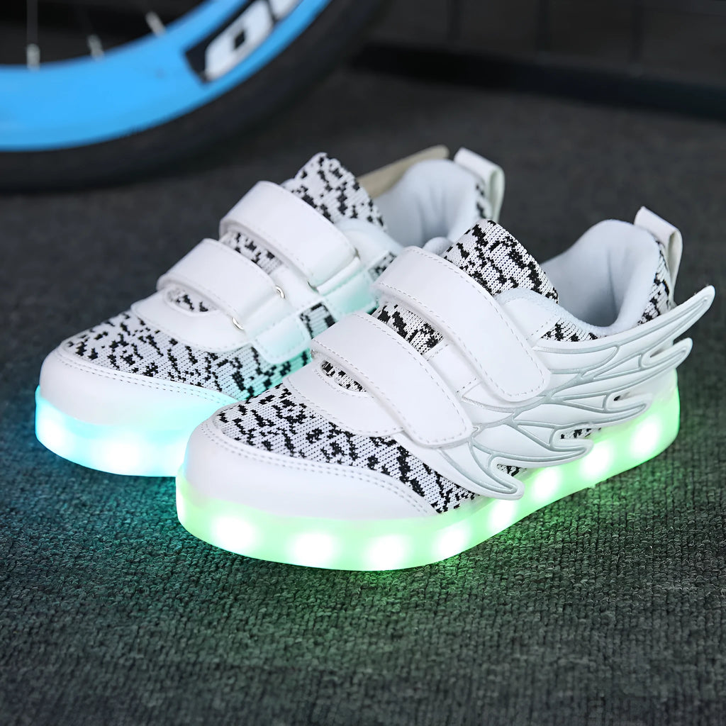 Children's plum red and white LED light-up sneakers showing flashing soles and USB charging cable.