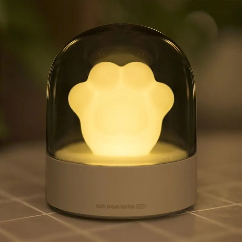 Grey or pink cat paw shaped night light with USB charging port and music box functionality