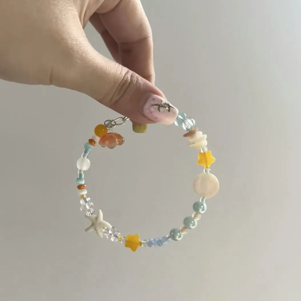 Orange mixed material women's bracelet with diamond shape and round decorative elements