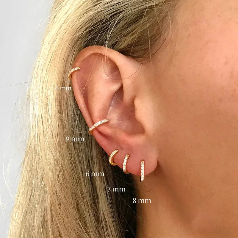 A pair of perforated circle stud earrings in a choice of gold, rose gold, or silver colour.
