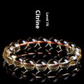 Natural citrine scattered beads bracelet showing polished gemstones in an original design on a wrist.