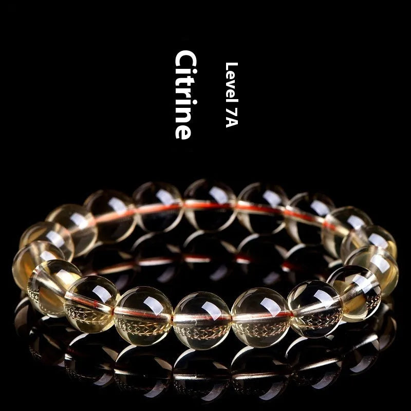 Natural citrine scattered beads bracelet showing polished gemstones in an original design on a wrist.