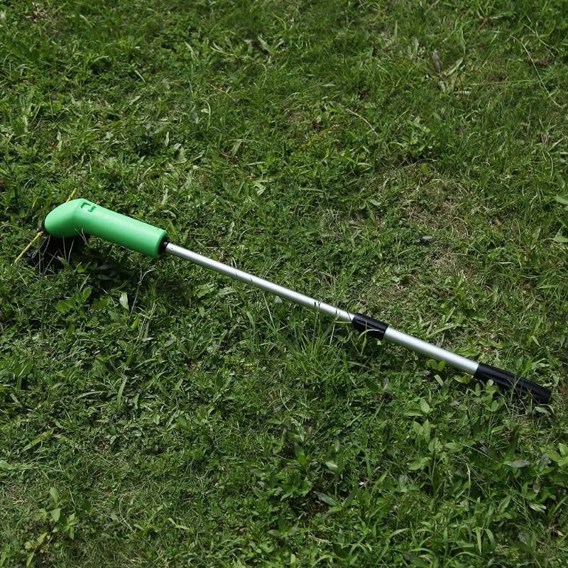 Cordless handheld lawn trimmer with extension pole and protective shield on green grass