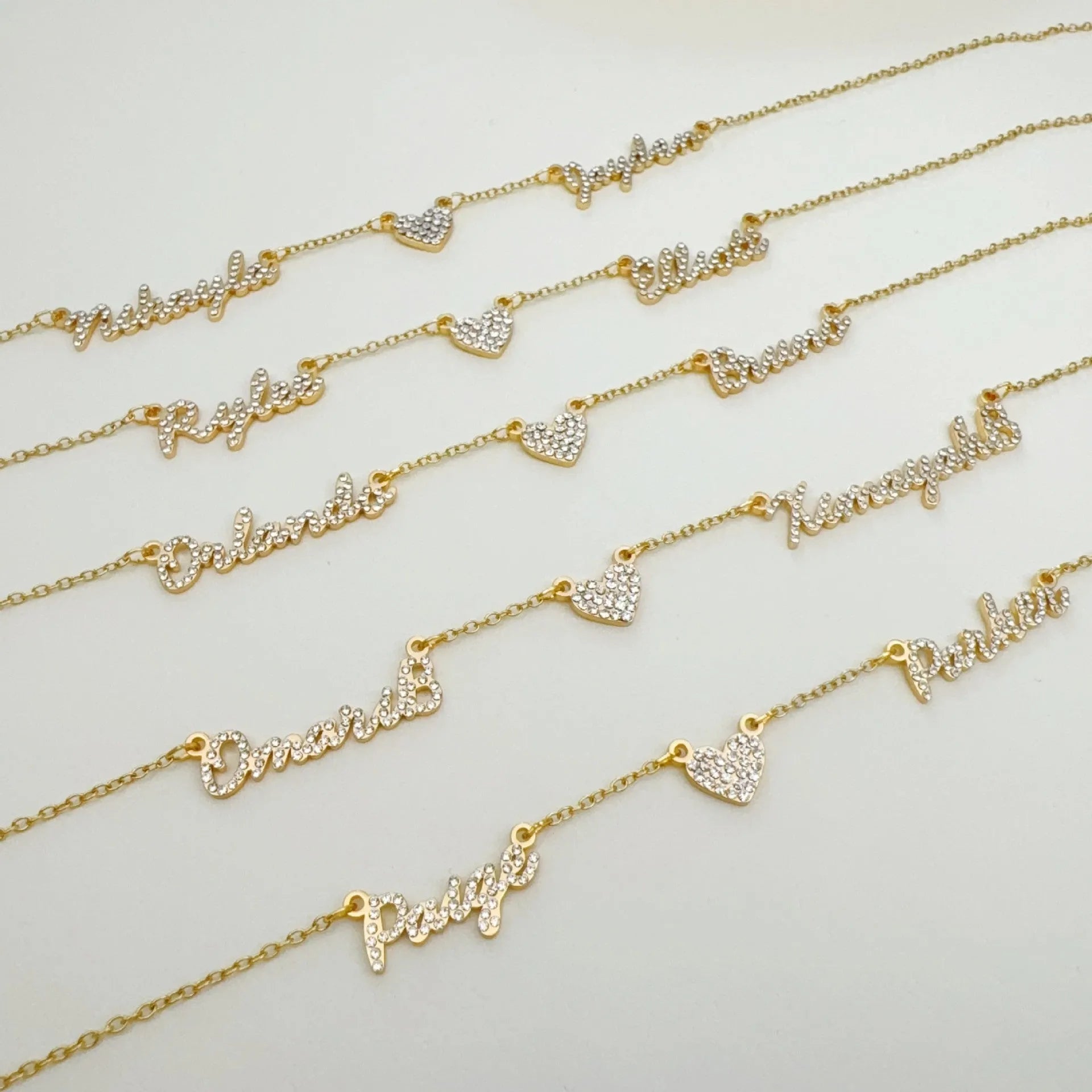 Customised diamond inlaid multi name necklace on stainless steel O-shaped chain, gold finish, with heart charms