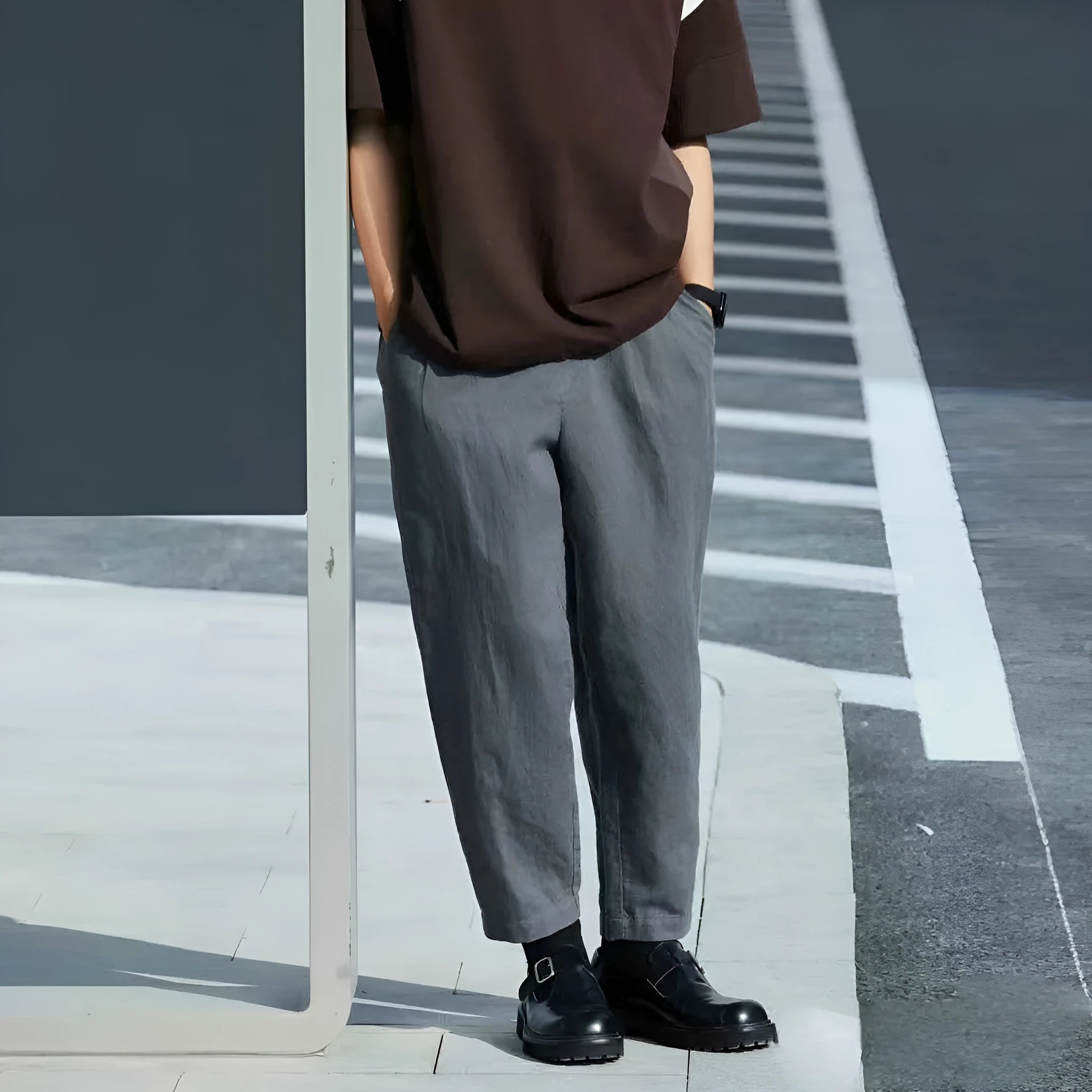 Man wearing beige loose straight-leg casual pants with a drawstring waist, showcasing summer casual style.