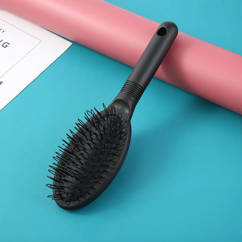 Black ring tooth hair extension comb on a white background, showing its 22cm length.