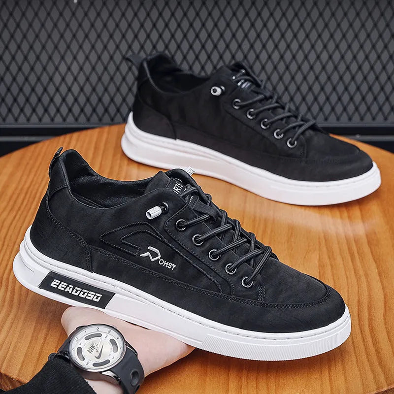 Grey men's canvas lace-up sneakers with stitching detail and a low-top round toe design.