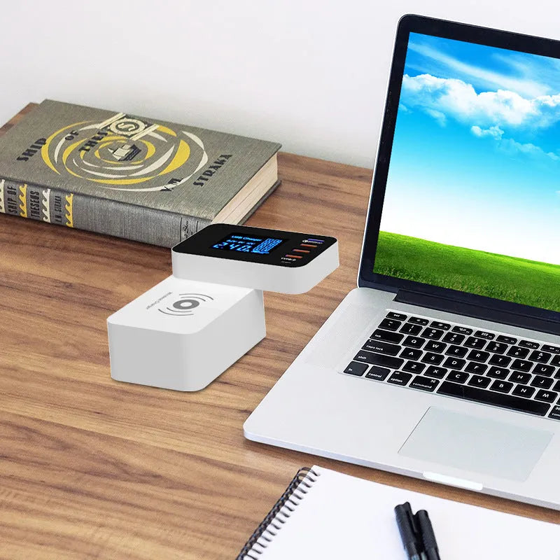 White multi-port USB and wireless fast charger with international plug adapters on a desk