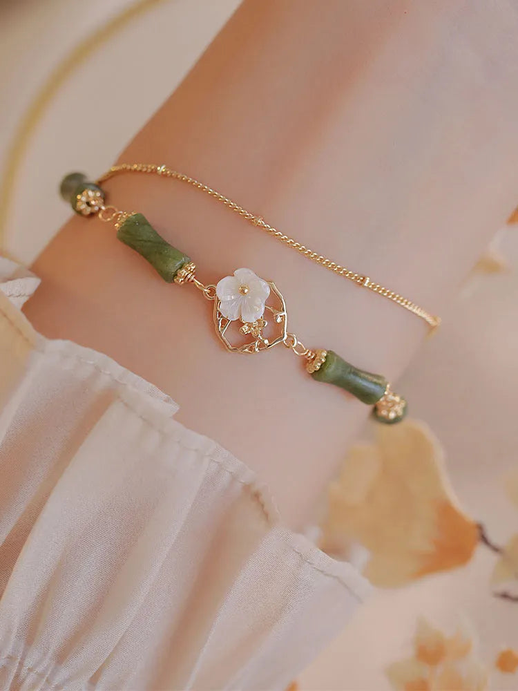 Handmade olivine bracelet with double layer design and twin charms on wrist