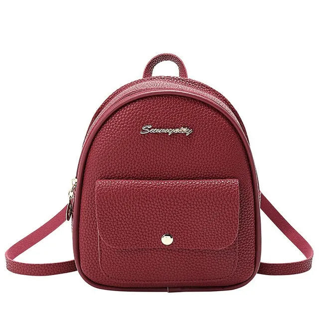 Small black PU shoulder backpack showing front zipper and dimensions