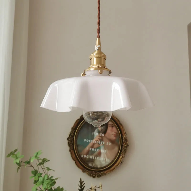 Medieval-style brass and cream glass chandelier light fitting with adjustable cord.